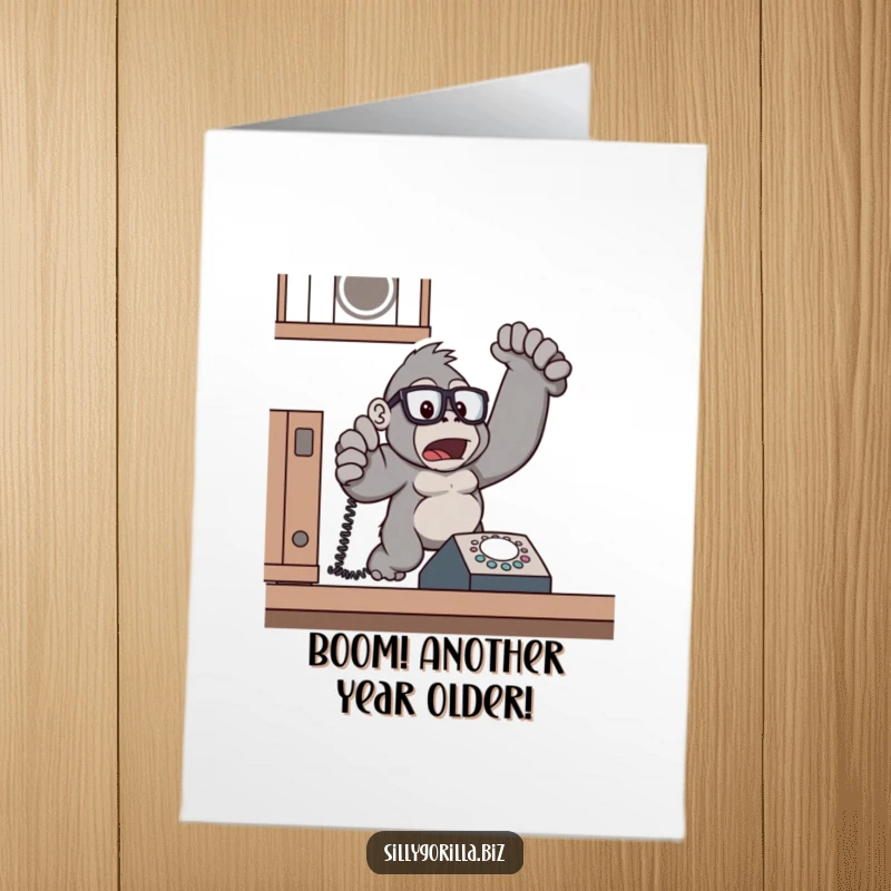 Funny Free Printable Birthday Card: Surprised gorilla in glasses jumps from ringing phone, office panic.